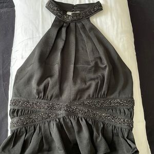 Black cropped halter top with sequins around the straps and waist. Open back